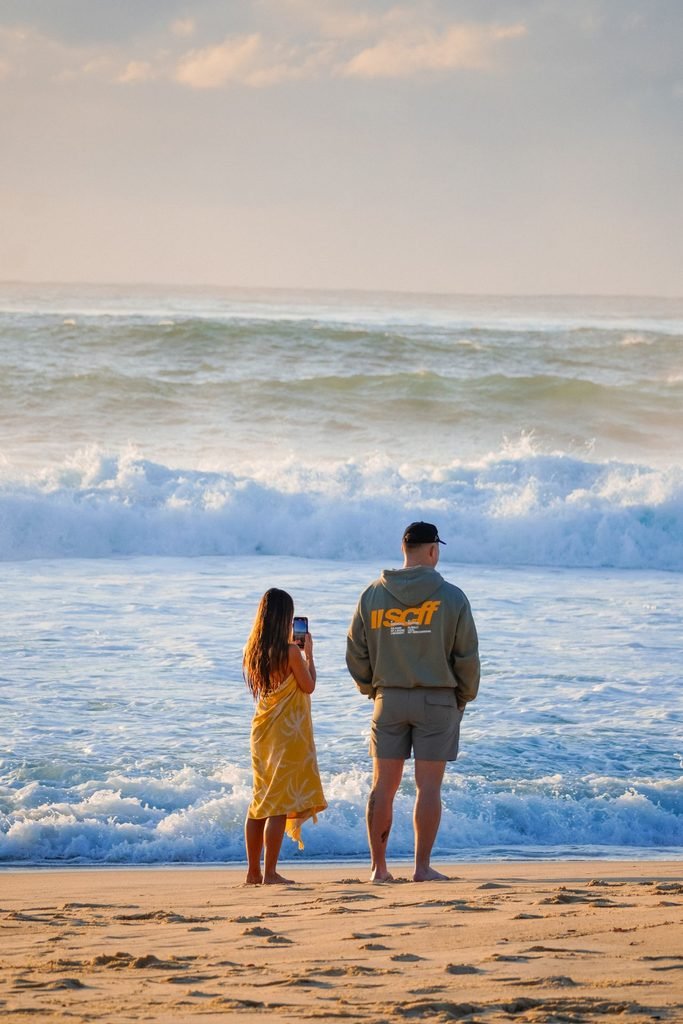 Couple enjoying a peaceful beach sunset during a Florida vacation.